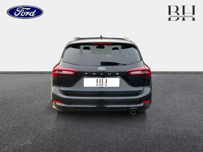 Vue arrière d'une Ford Focus SW 2024 noir Agate métallisé avec feux LED et sortie d'échappement chromée.