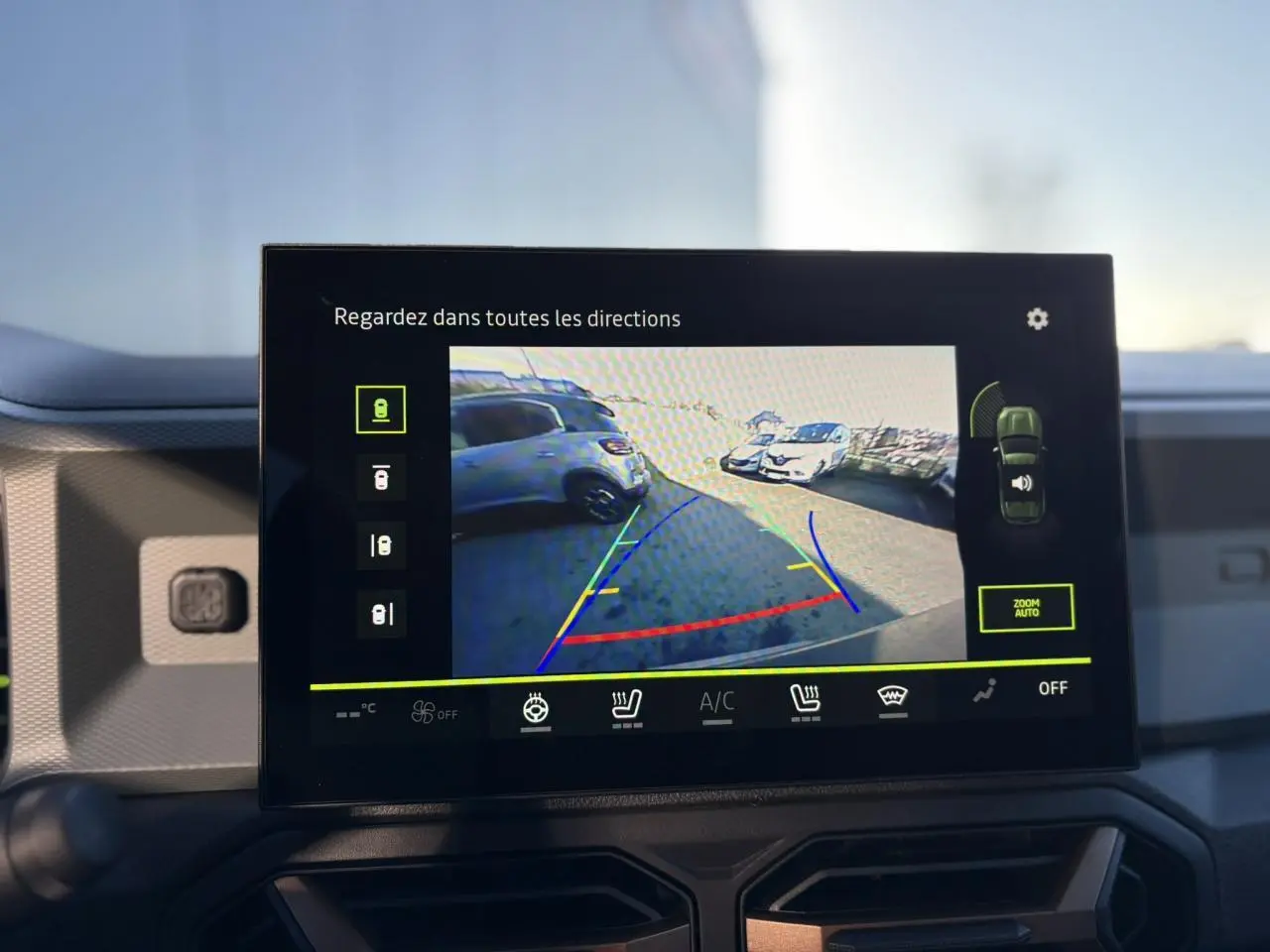 Écran tactile intérieur montrant la caméra 360° du Dacia Duster gris schiste en marche arrière.