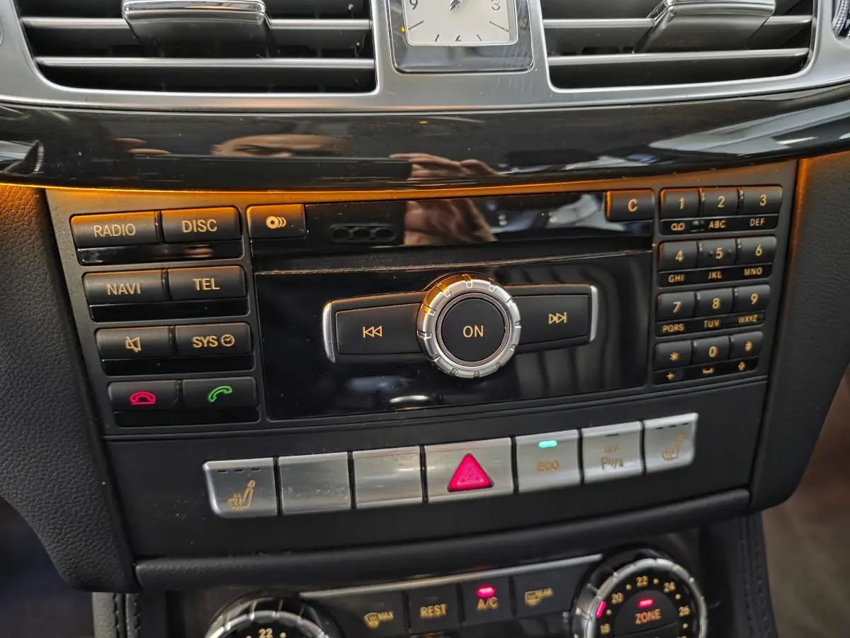 Gros plan sur la console centrale noire de la Mercedes CLS 250 CDI 2011 avec commandes audio et climatisation THERMOTRONIC.