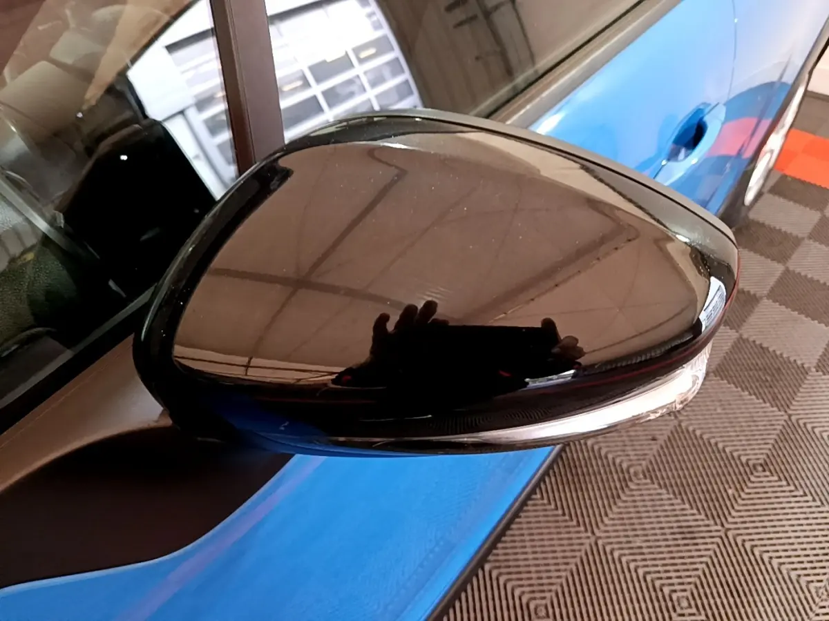 Rétroviseur noir côté gauche en gros plan sur Citroën C3 bleu, avec clignotant intégré visible.