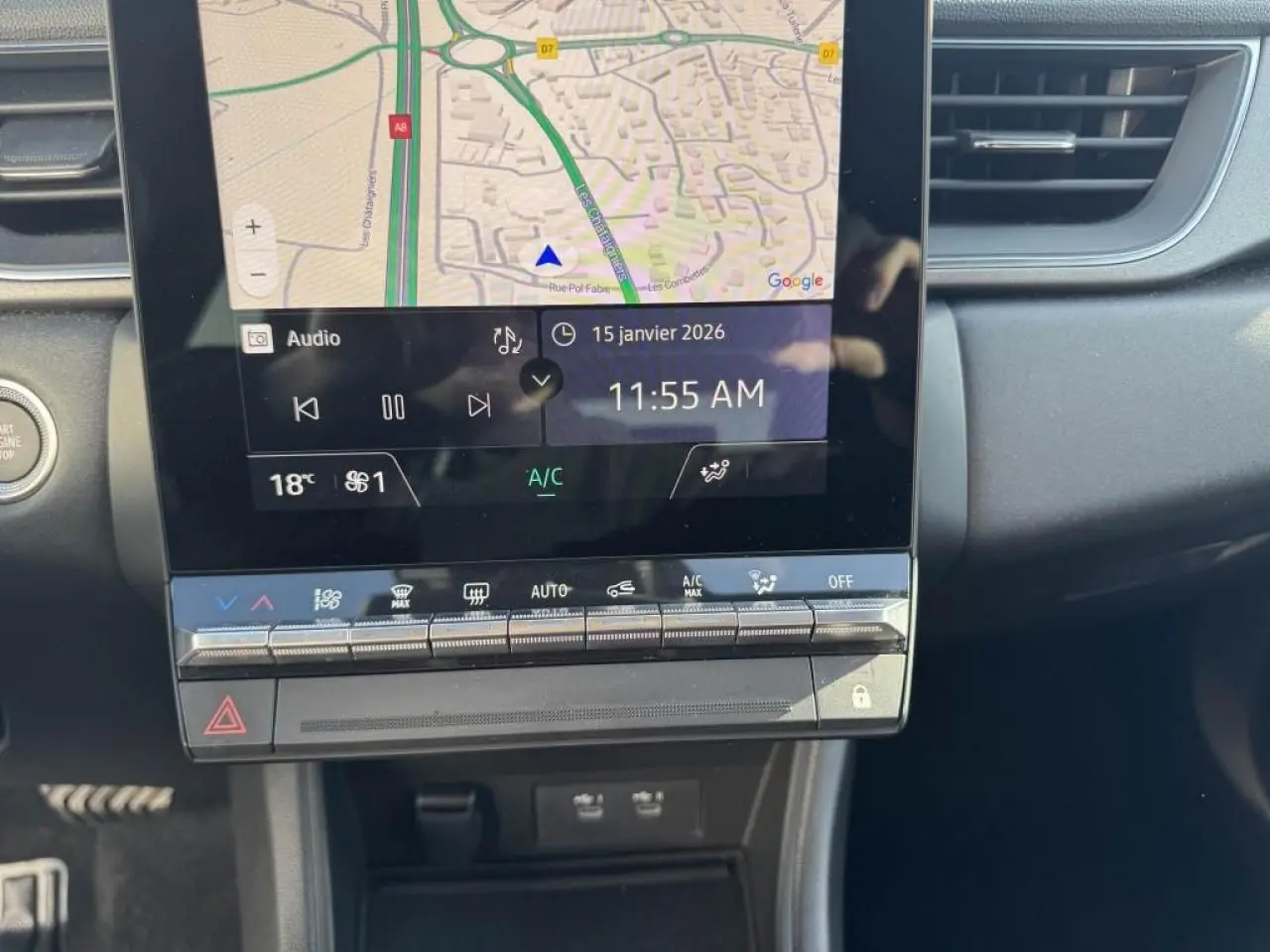 Vue rapprochée de l’écran tactile central du Renault Captur II gris Cassiopée avec navigation et commandes climatisation.