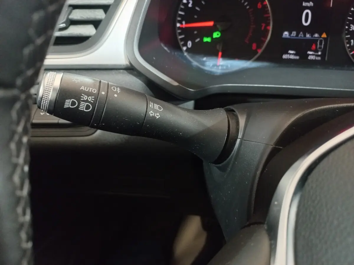 Gros plan sur la manette des phares et clignotants à gauche du volant du Renault Captur Business gris clair 2020.
