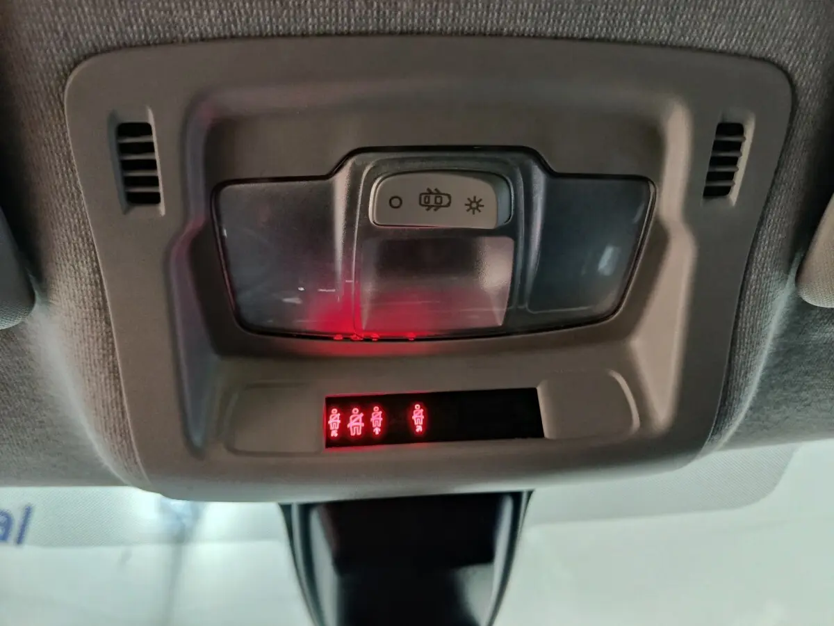 Vue intérieure du plafonnier avec éclairage et indicateurs de ceintures allumés dans une Citroën C3 gris foncé 2024.