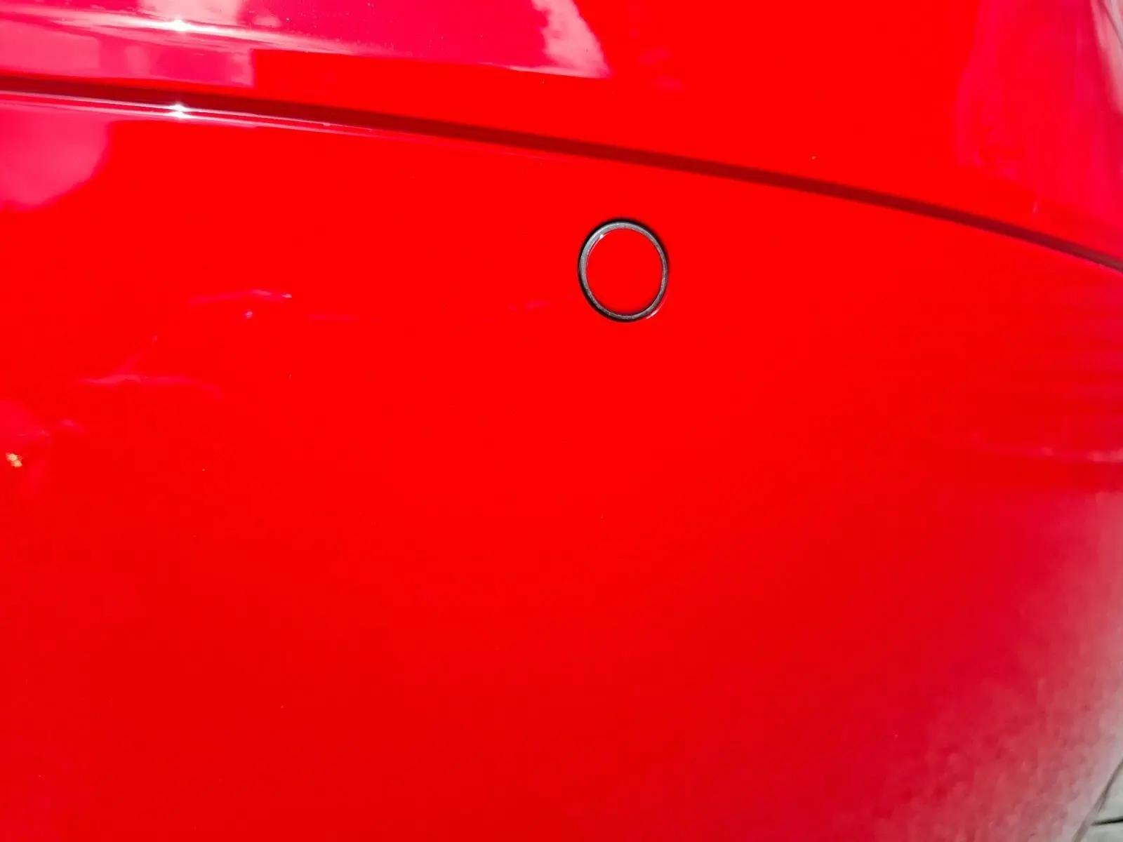 Gros plan sur le capteur de radar de stationnement arrière du pare-chocs rouge d’une Audi TT 3.2 V6 Quattro 2007.