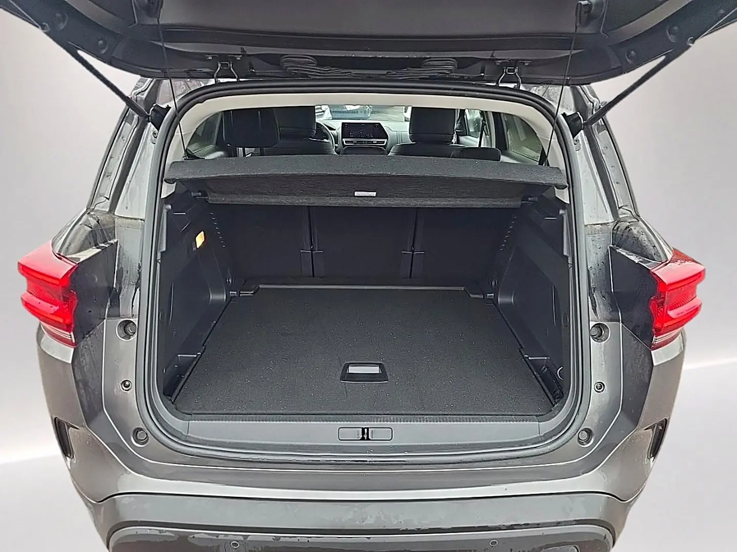 Coffre ouvert vu de l'arrière d'un Citroën C5 Aircross gris 2025, montrant l'espace de chargement vide.