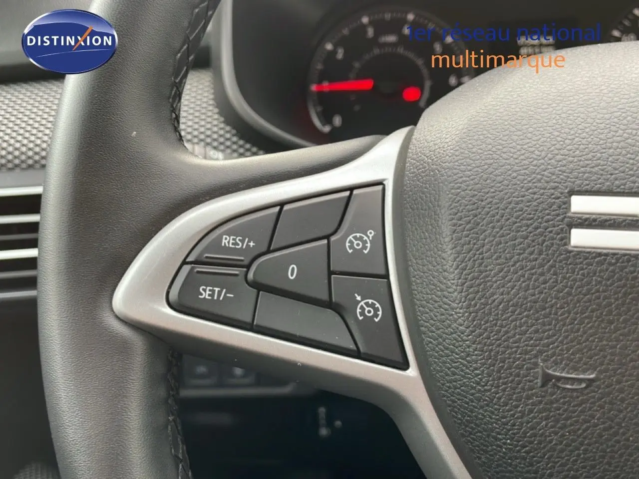Gros plan sur les commandes au volant du Dacia Jogger 2025, version kaki lichen, montrant les boutons de régulateur de vitesse.