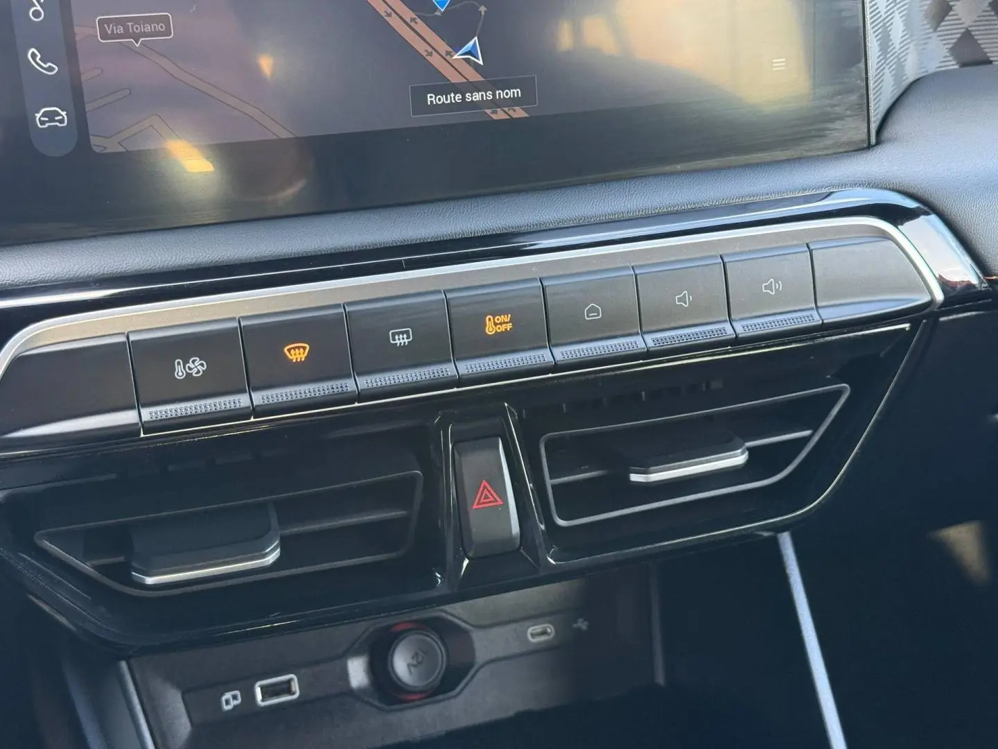 Vue rapprochée de la console centrale du MG3 2025, boutons de climatisation et prises USB visibles, finition noire brillante.