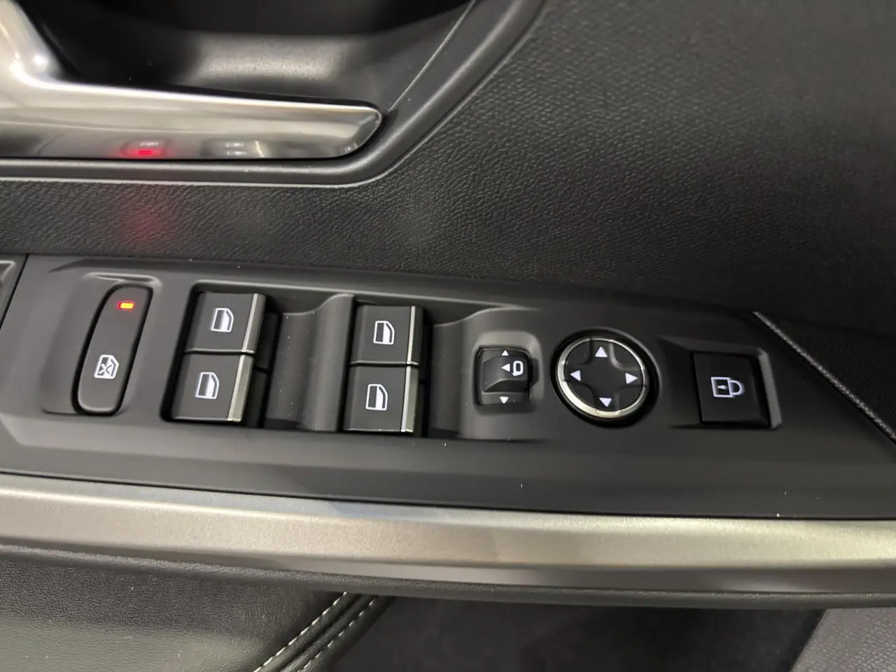 Gros plan sur les commandes de lève-vitres et rétroviseurs côté conducteur du Peugeot 3008 gris Artense.