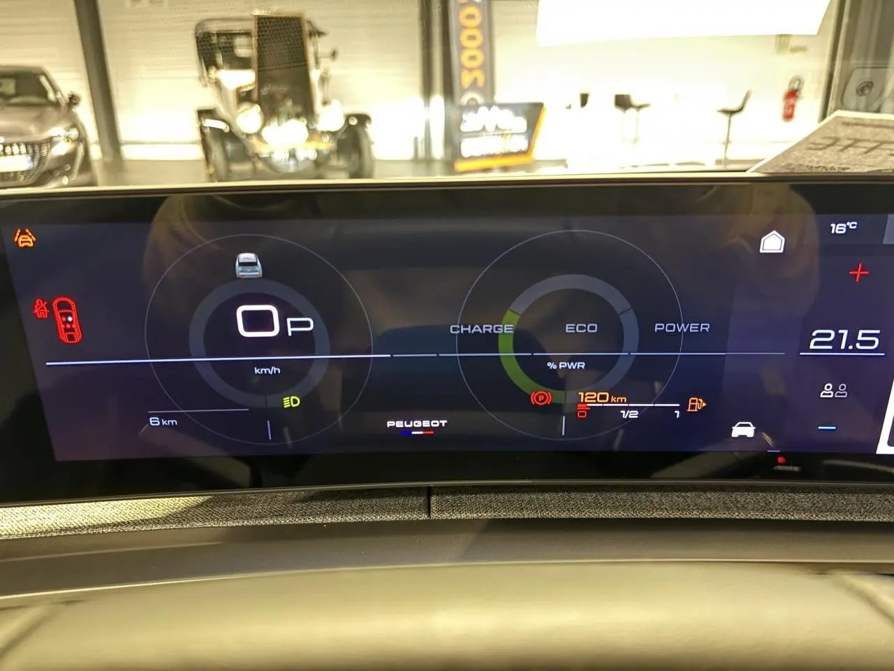 Affichage numérique du tableau de bord du Peugeot 3008 hybride, montrant la vitesse, l'autonomie et les modes de puissance.