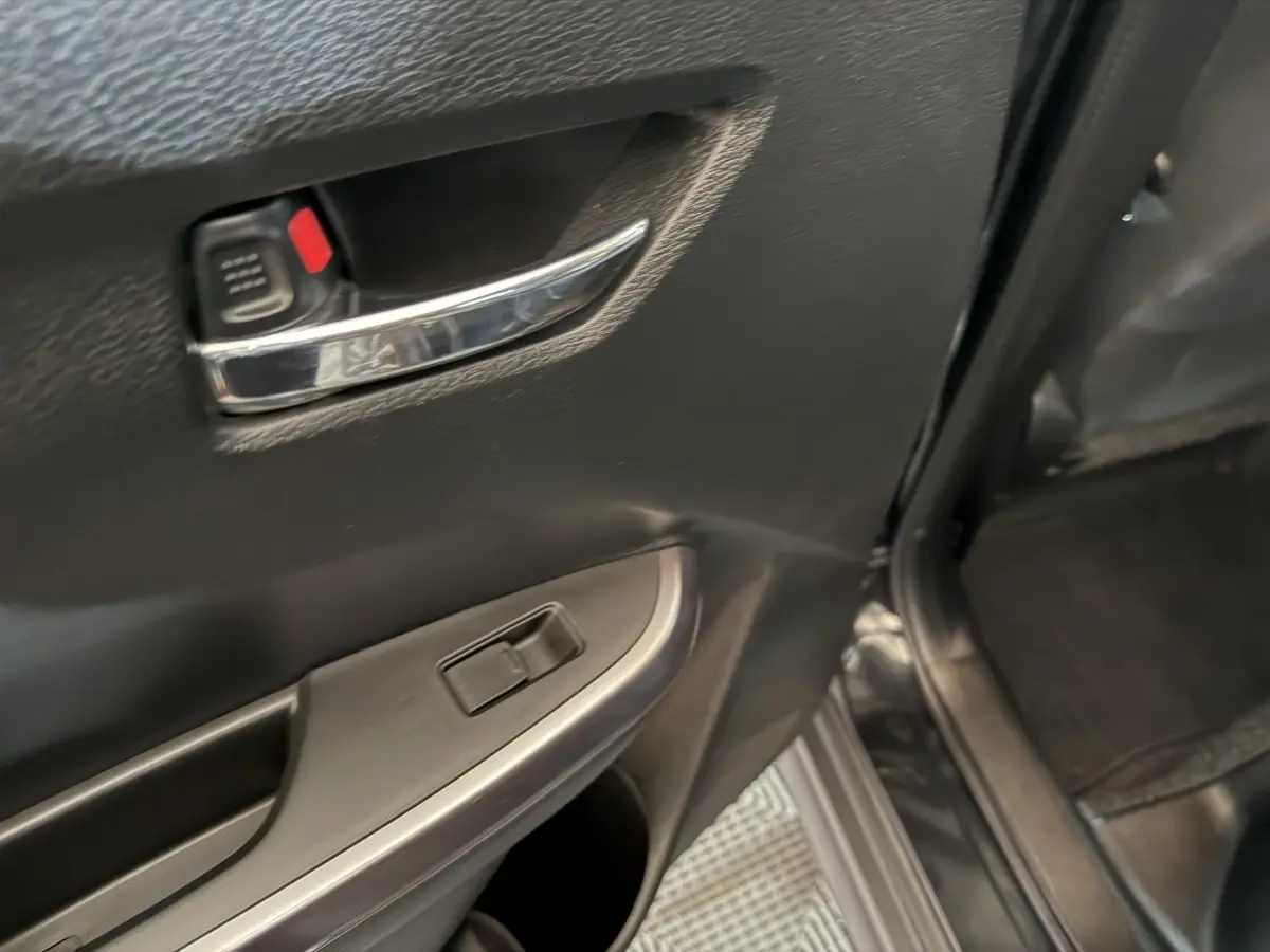 Poignée de porte intérieure côté gauche en plastique noir avec commande de vitre sur Suzuki Vitara 2022 noir.