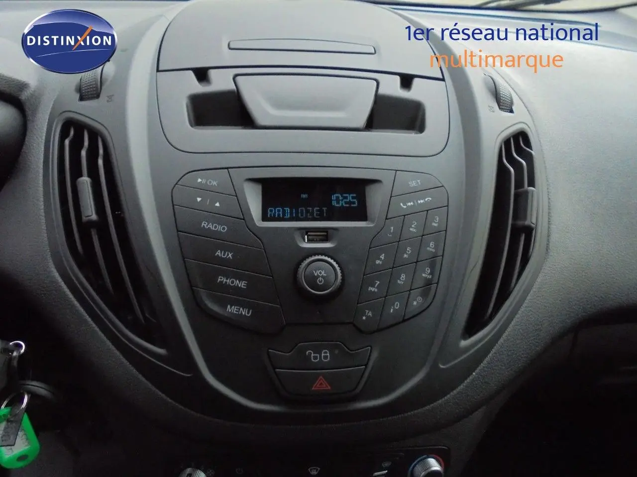 Vue rapprochée du tableau de bord noir du Ford Transit Courier 2022 avec console centrale et commandes radio.