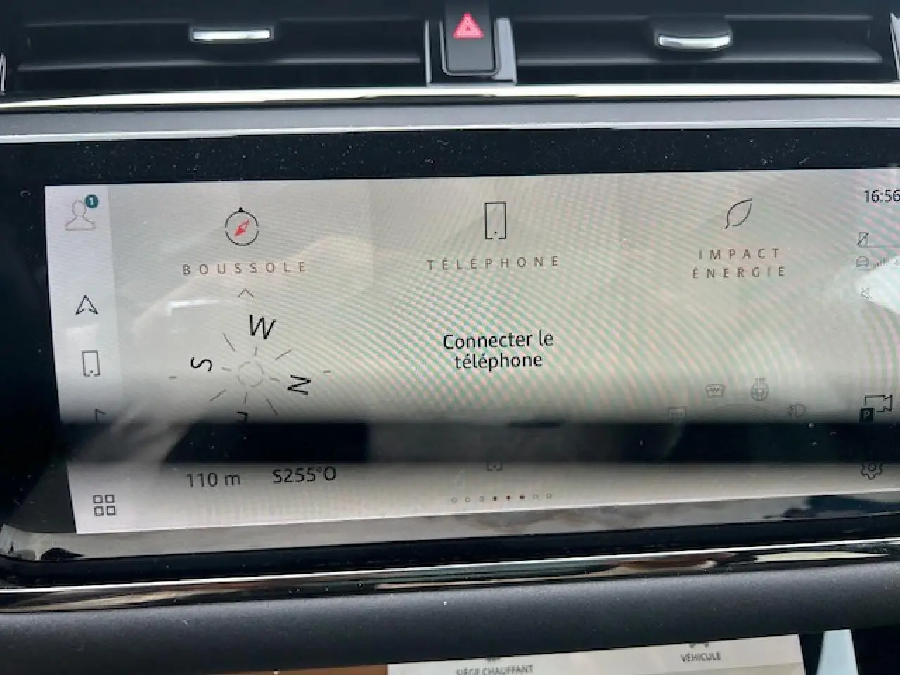 Écran tactile central du Range Rover Evoque gris foncé, affichant la boussole et options connectivité.
