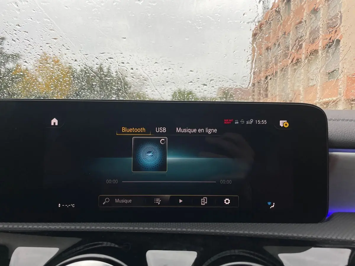 Écran tactile central de la Mercedes CLA Shooting Brake blanc 2021 affichant le menu Bluetooth sous la pluie.