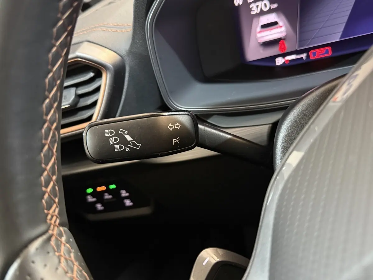 Gros plan sur la manette de clignotant noire à gauche du volant dans l'habitacle du CUPRA Formentor noir 2023.