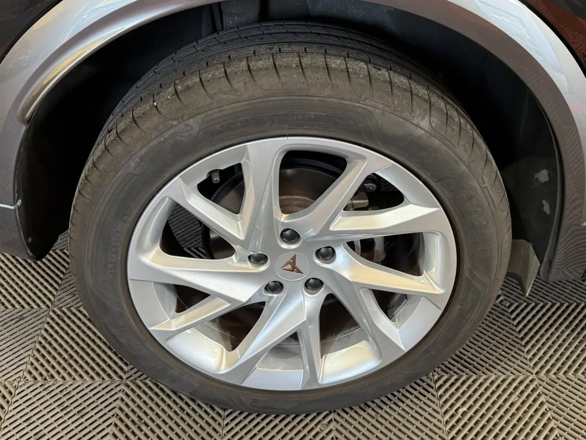 Gros plan sur la jante argentée à 5 branches doubles du côté arrière droit d'un CUPRA Formentor noir.