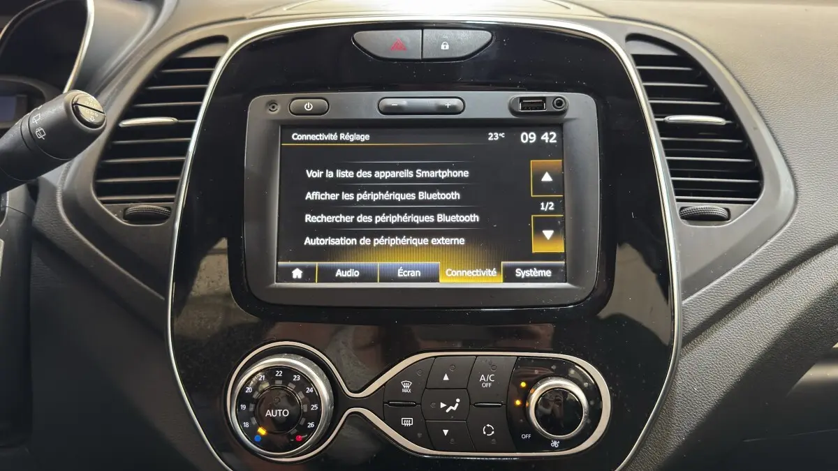Vue rapprochée du tableau de bord noir du Renault Captur Intens TCe 90 2019, avec écran tactile affichant les réglages Bluetooth.
