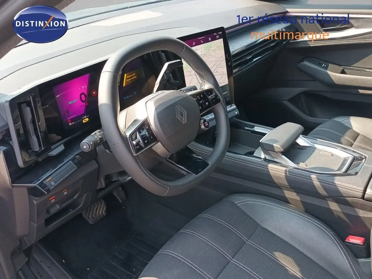 Vue intérieure côté conducteur du Renault Austral E-Tech hybride 2025, tableau de bord numérique et sellerie noire.