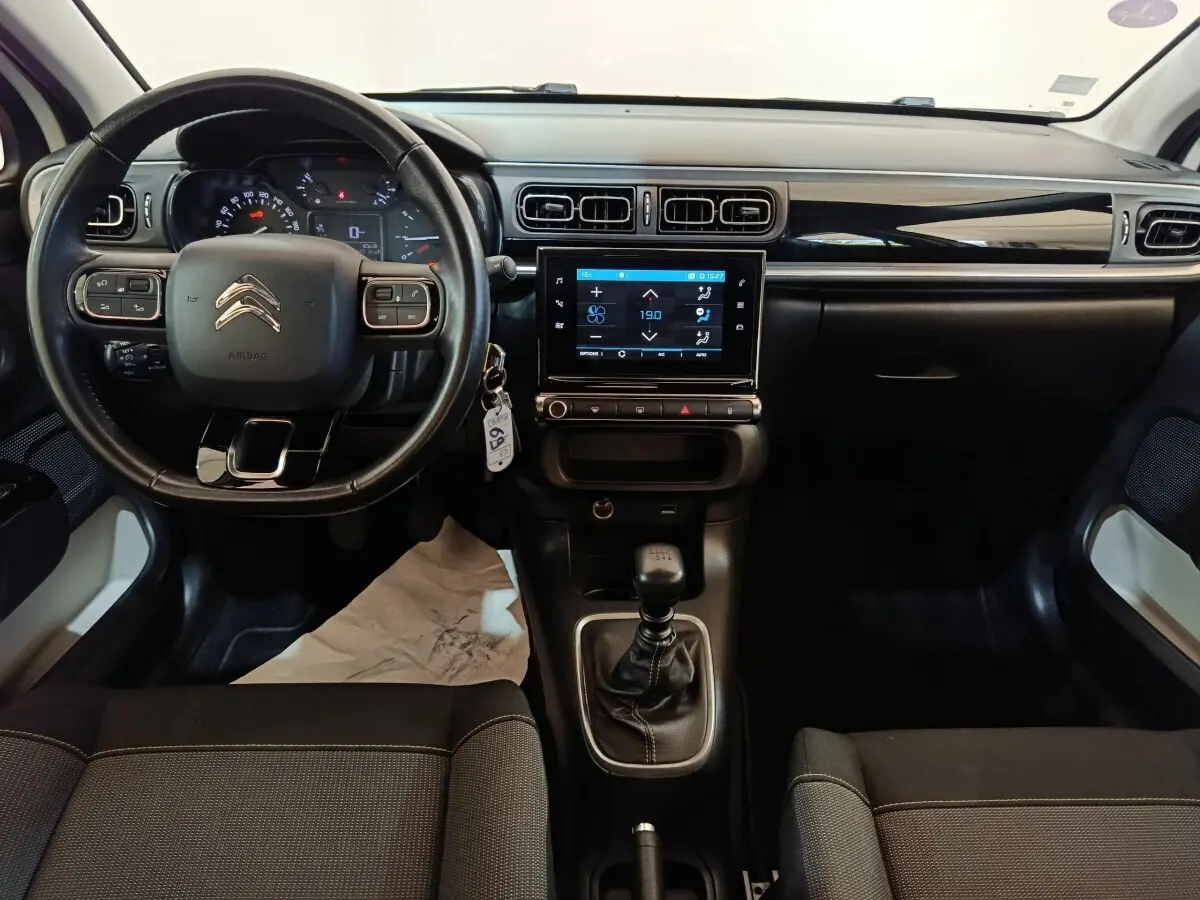 Vue intérieure avant du tableau de bord et volant cuir noir d'une Citroën C3 2021 avec écran tactile central.