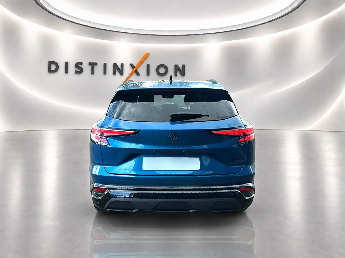 Vue arrière du Renault Austral 2026 bleu outremer avec feux LED et hayon motorisé dans un showroom épuré.