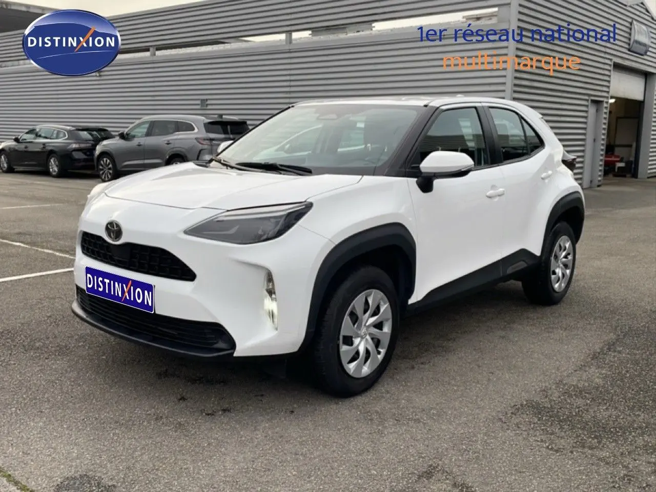 Toyota Yaris Cross blanc pur vue 3/4 avant droit, SUV compact avec protections noires sur les passages de roues.