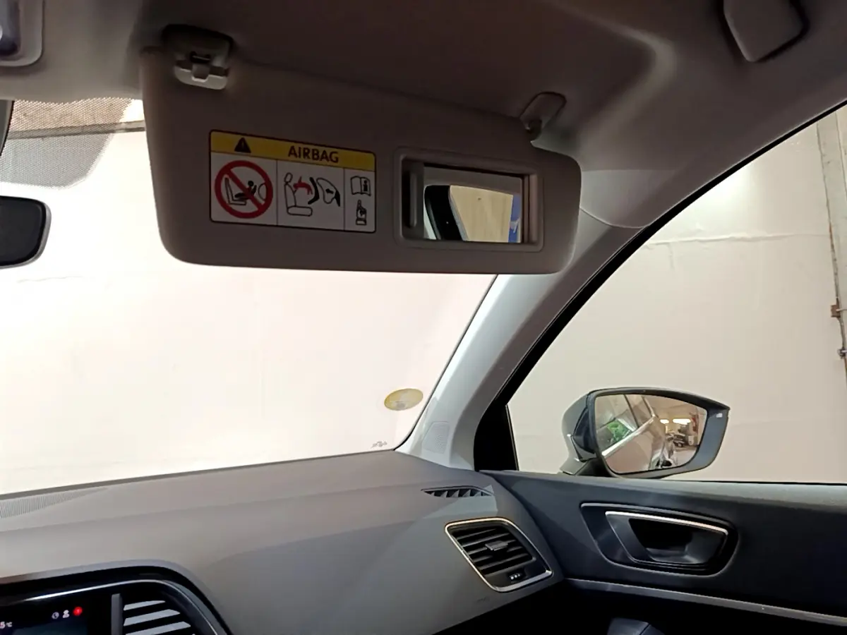 Intérieur côté passager du SEAT Ateca noir 2022, avec pare-soleil abaissé et rétroviseur extérieur visible.