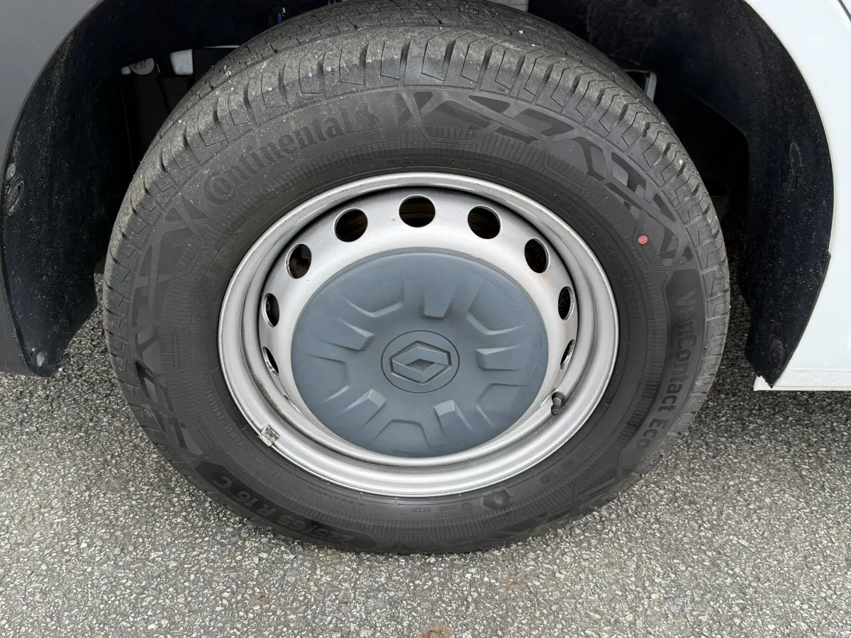 Gros plan sur la roue avant droite du Renault Master blanc avec jante acier et logo Renault au centre.