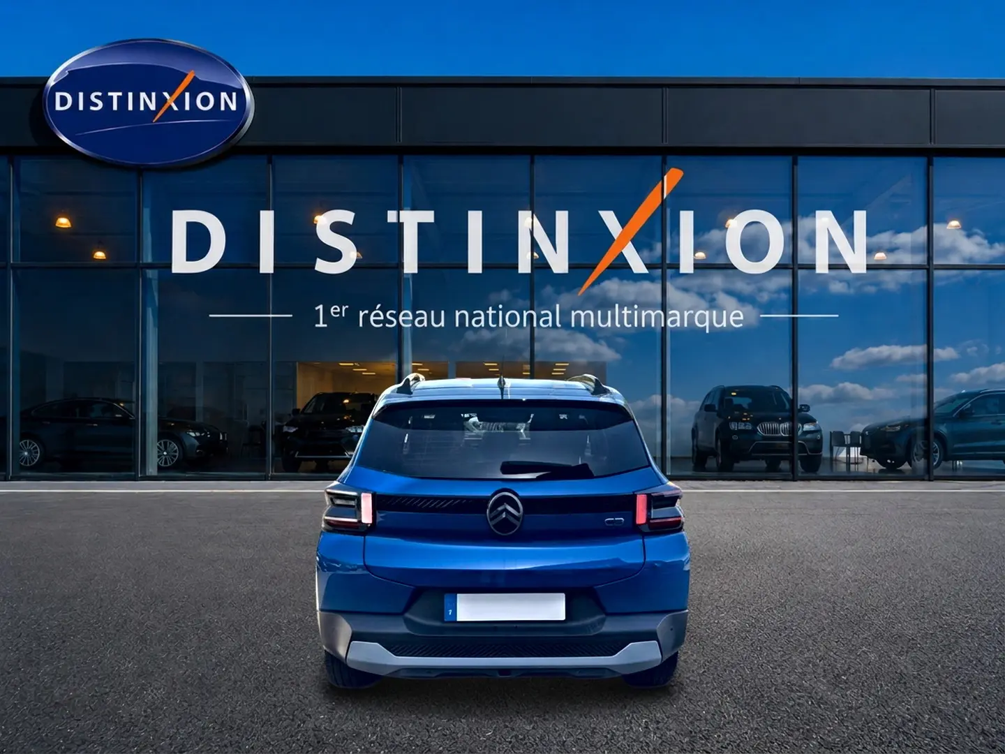 Vue arrière d'une Citroën C3 bleu 2025 avec feux arrière LED, stationnée devant une vitrine Distinxion.