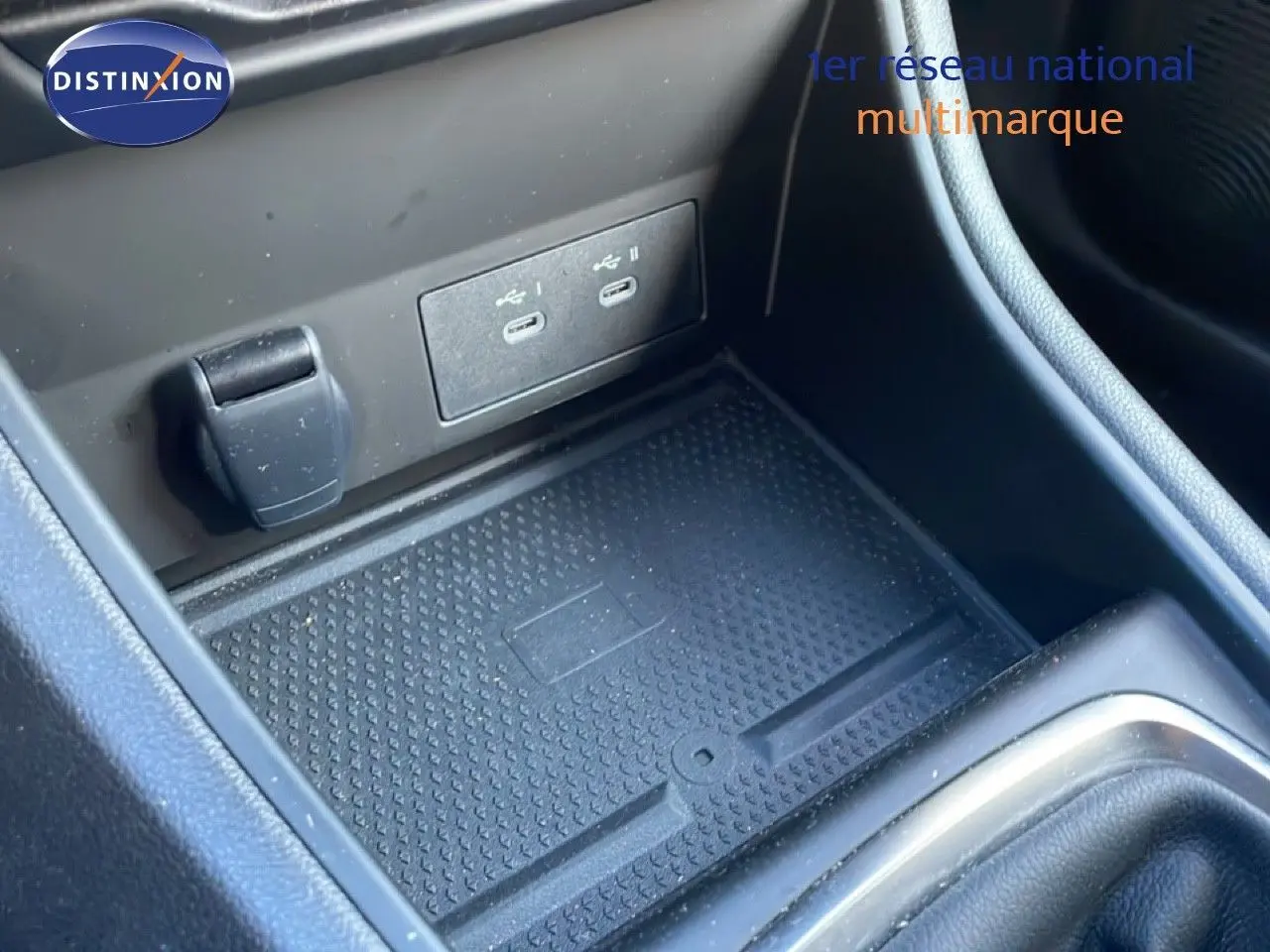 Gros plan sur la console centrale du Renault Captur 2025, montrant les ports USB et un espace de rangement noir.