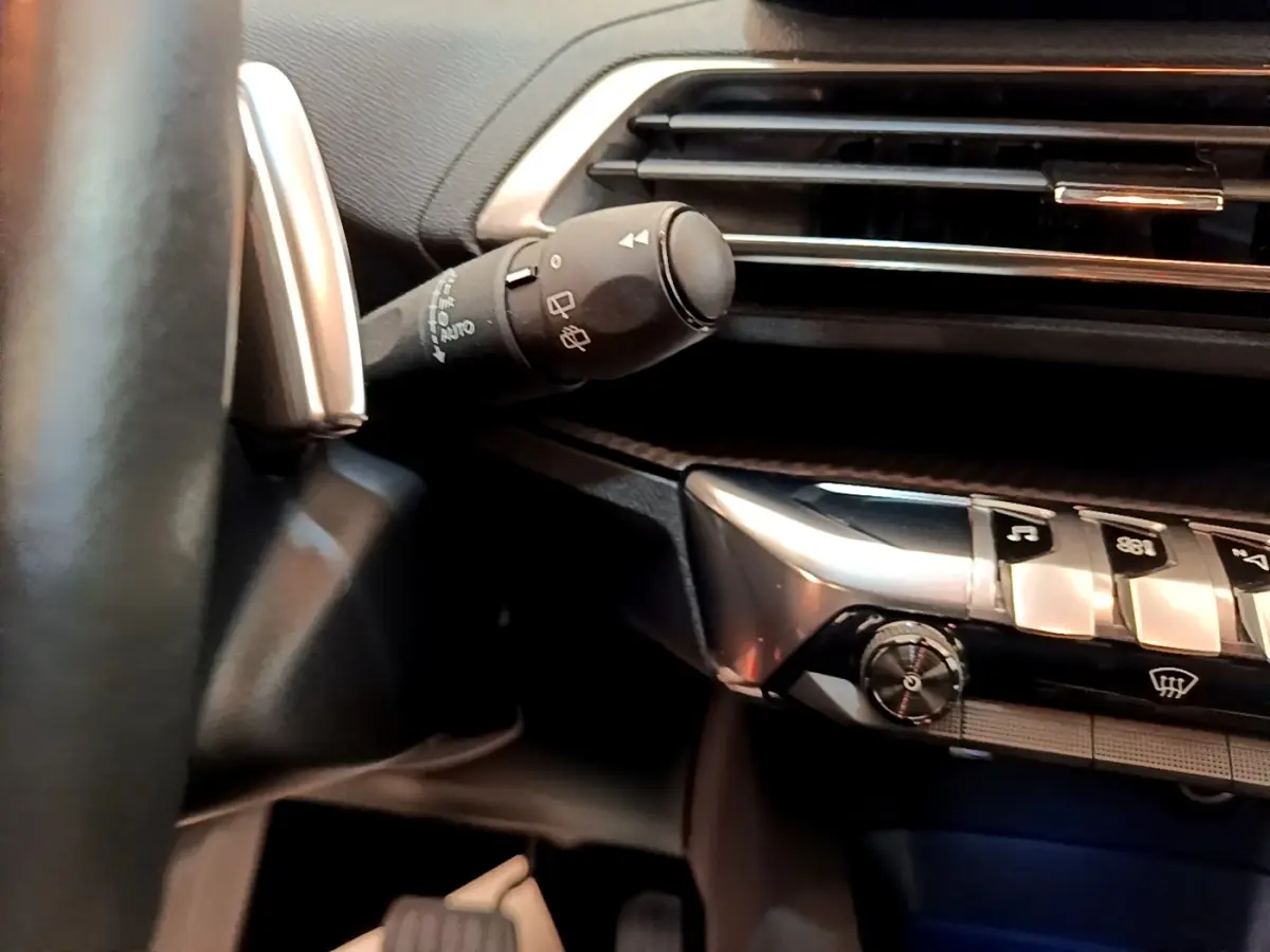 Détail intérieur du volant cuir et commandes de la Peugeot 5008 Active Pack 2021, avec tableau de bord noir et argent.