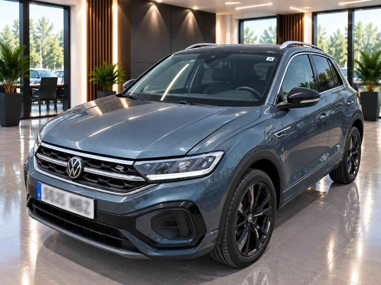 Volkswagen T-Roc 2025 gris métal en 3/4 avant droit avec jantes noires et détails R-Line visibles.