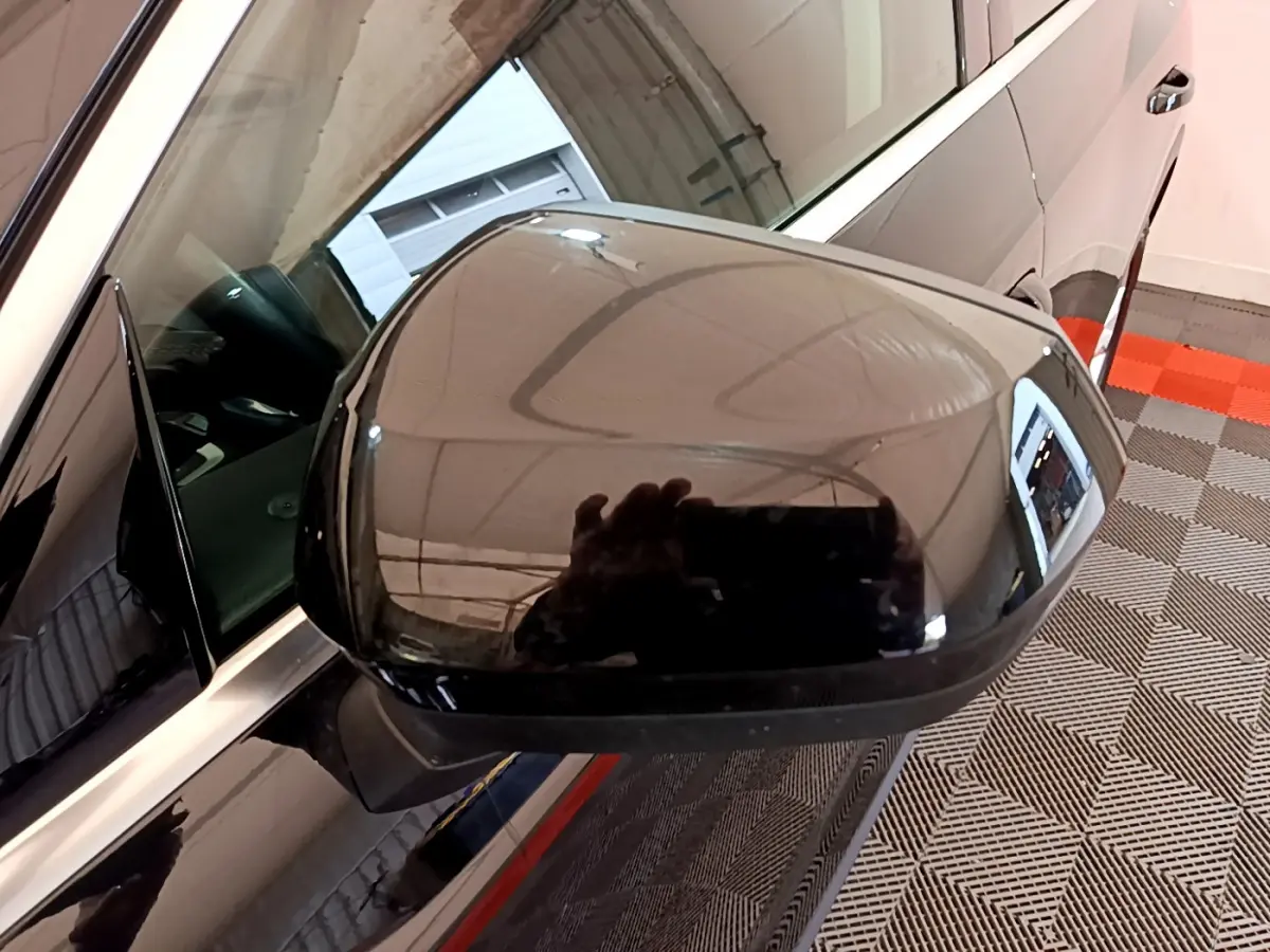 Rétroviseur noir côté gauche d’un Audi Q3 35 TDI 2021 avec caméra intégrée et carrosserie brillante