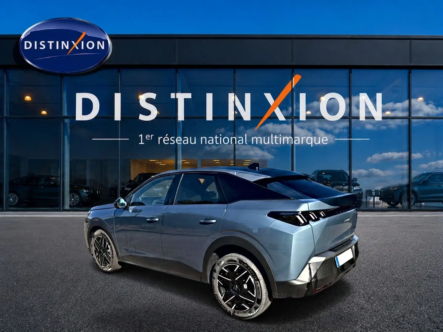 Peugeot 3008 bleu en 3/4 arrière droit, avec jantes alu noires et toit noir, devant vitrine Distinxion.