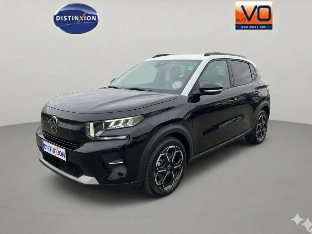 Citroën C3 noir vue 3/4 avant droit, avec toit blanc, barres de toit et jantes alliage 17 pouces.