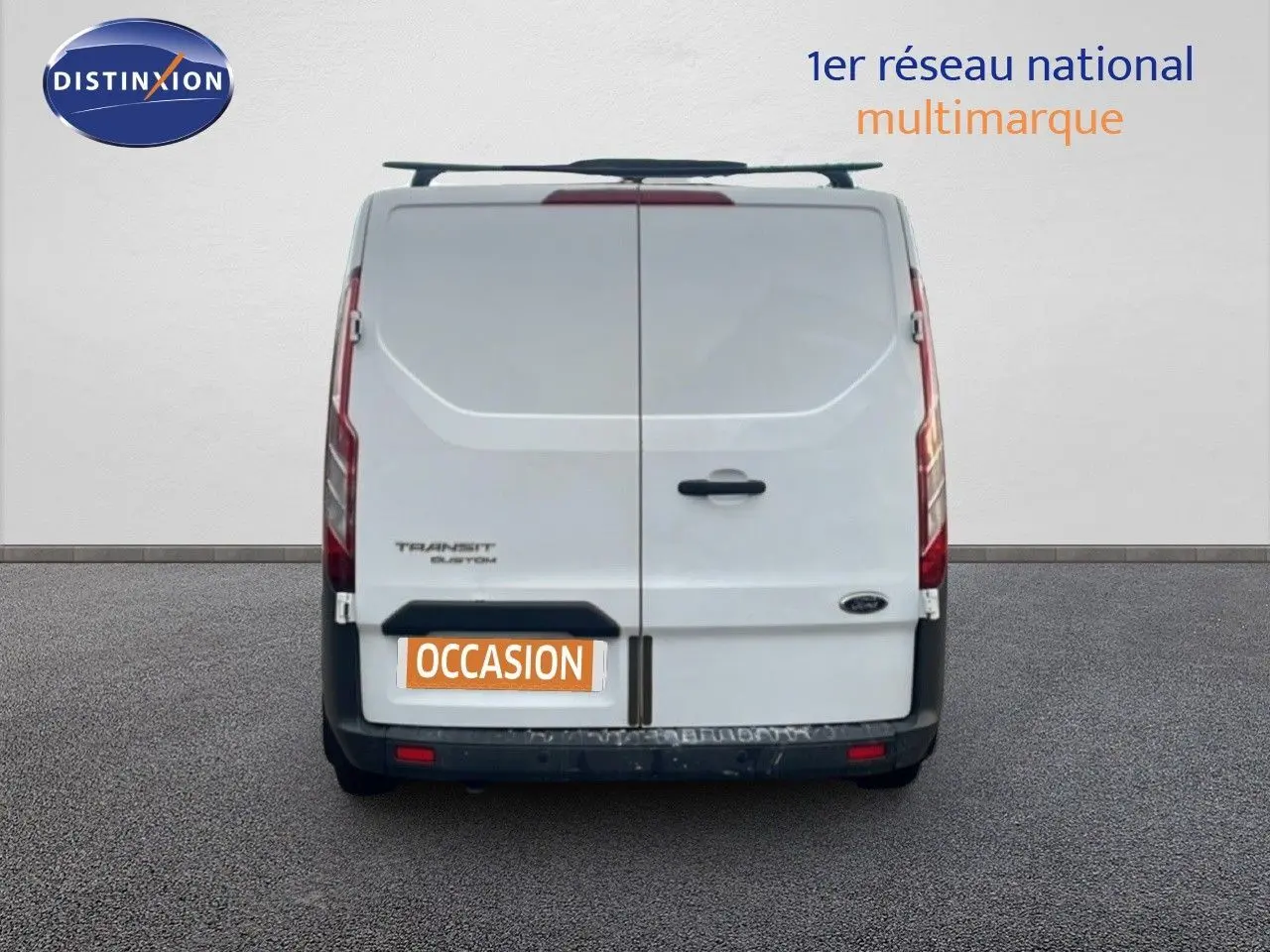 Vue arrière d'un fourgon Ford Transit Custom blanc de 2016 avec portes battantes et plaque "OCCASION".