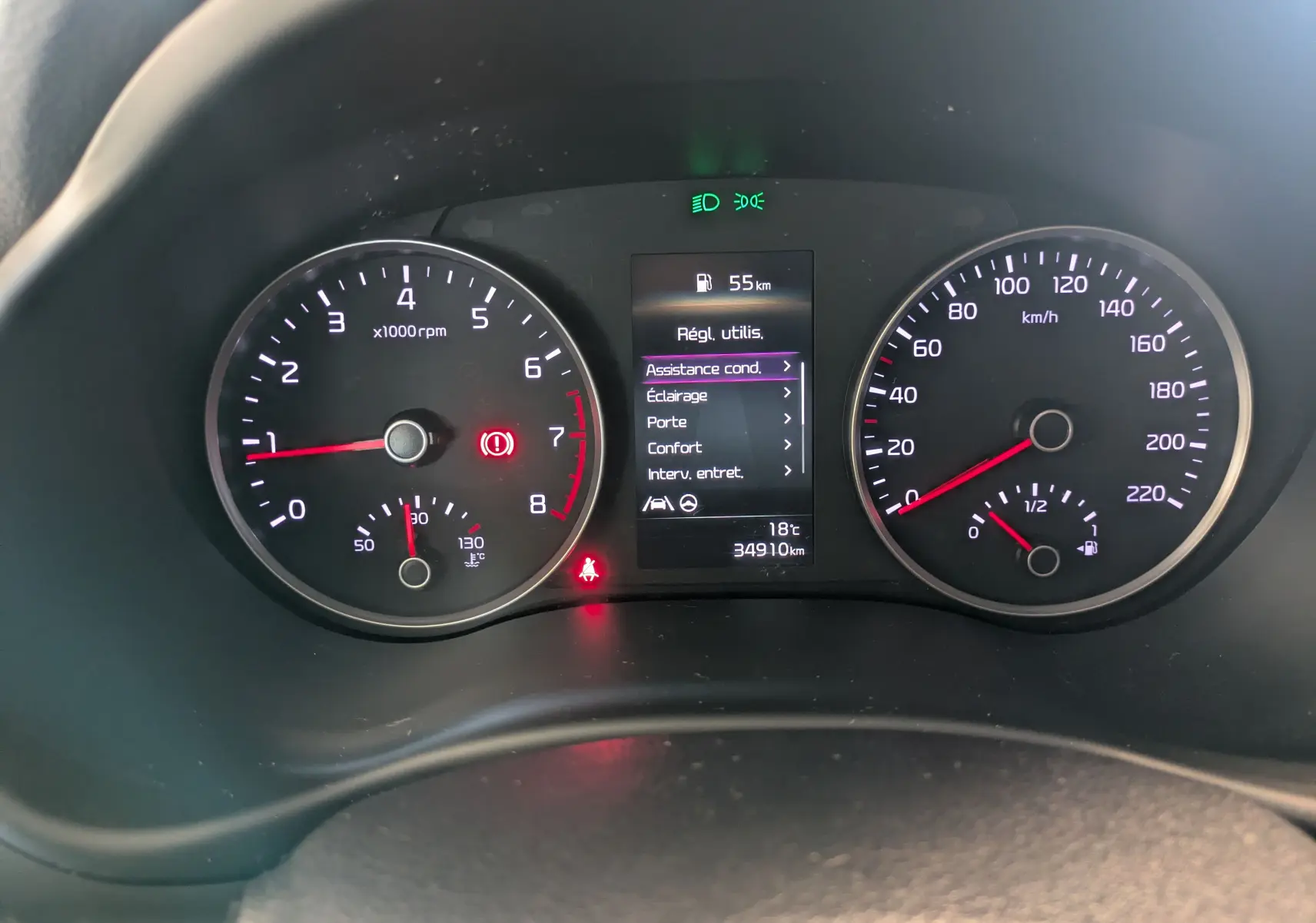 Vue rapprochée du tableau de bord du Kia Stonic blanc, affichant compte-tours, vitesse et écran central des réglages.