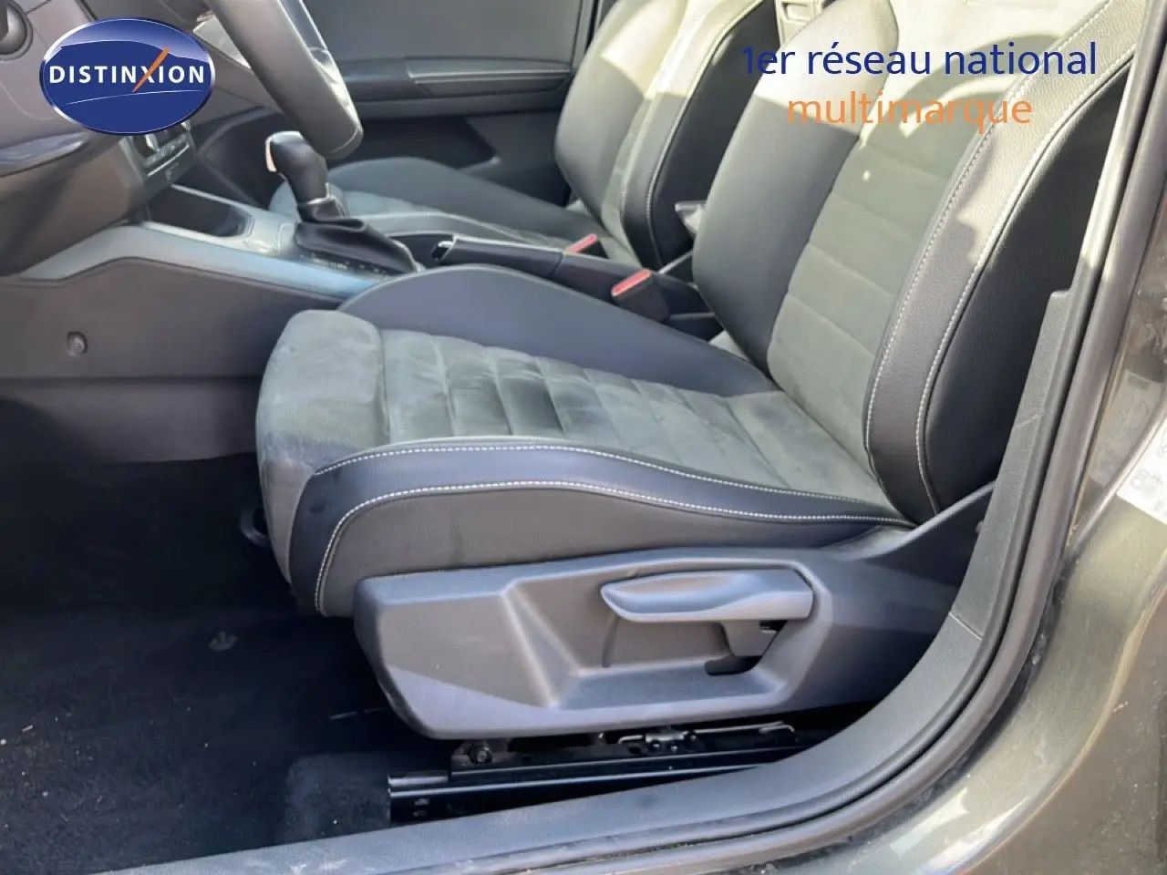 Vue intérieure côté conducteur du siège avant en tissu et cuir noir du SEAT Arona gris magnétique 2025 avec levier de vitesses automatique.