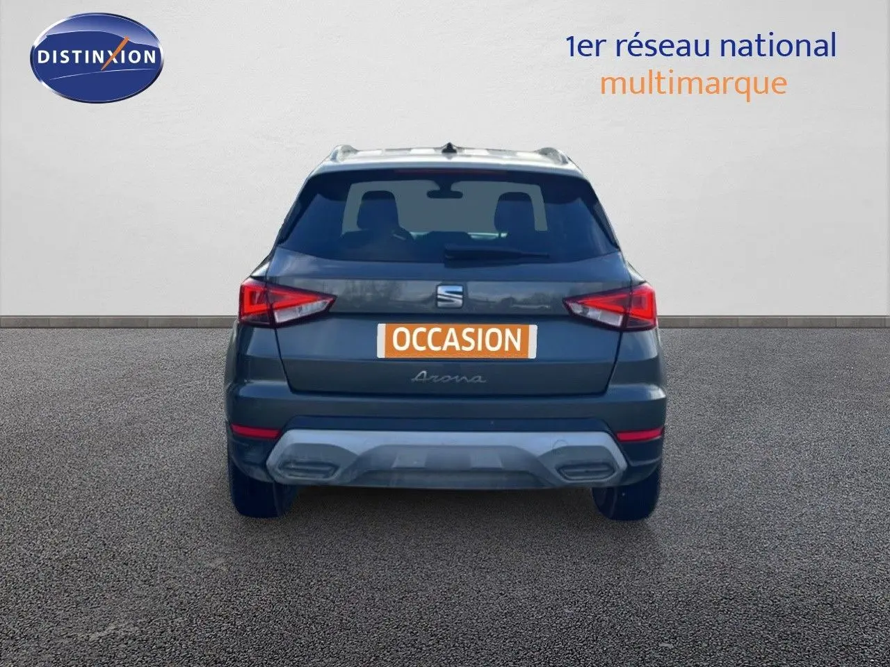 Vue arrière d'un SEAT Arona gris magnétique avec toit blanc, affichant une plaque "OCCASION" sur fond orange.