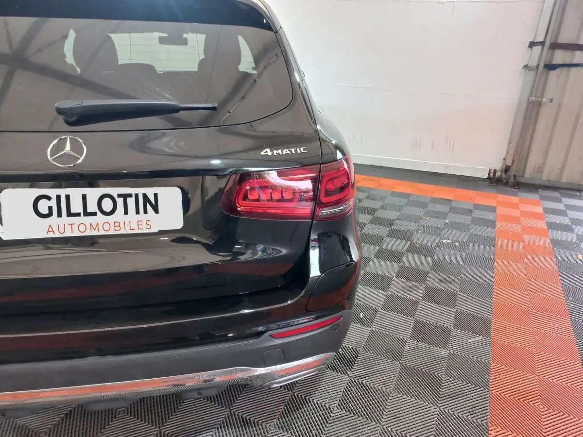 Vue arrière droite d'un Mercedes GLC 300 E Business Line 4MATIC noir avec feux LED et logo 4MATIC visible.