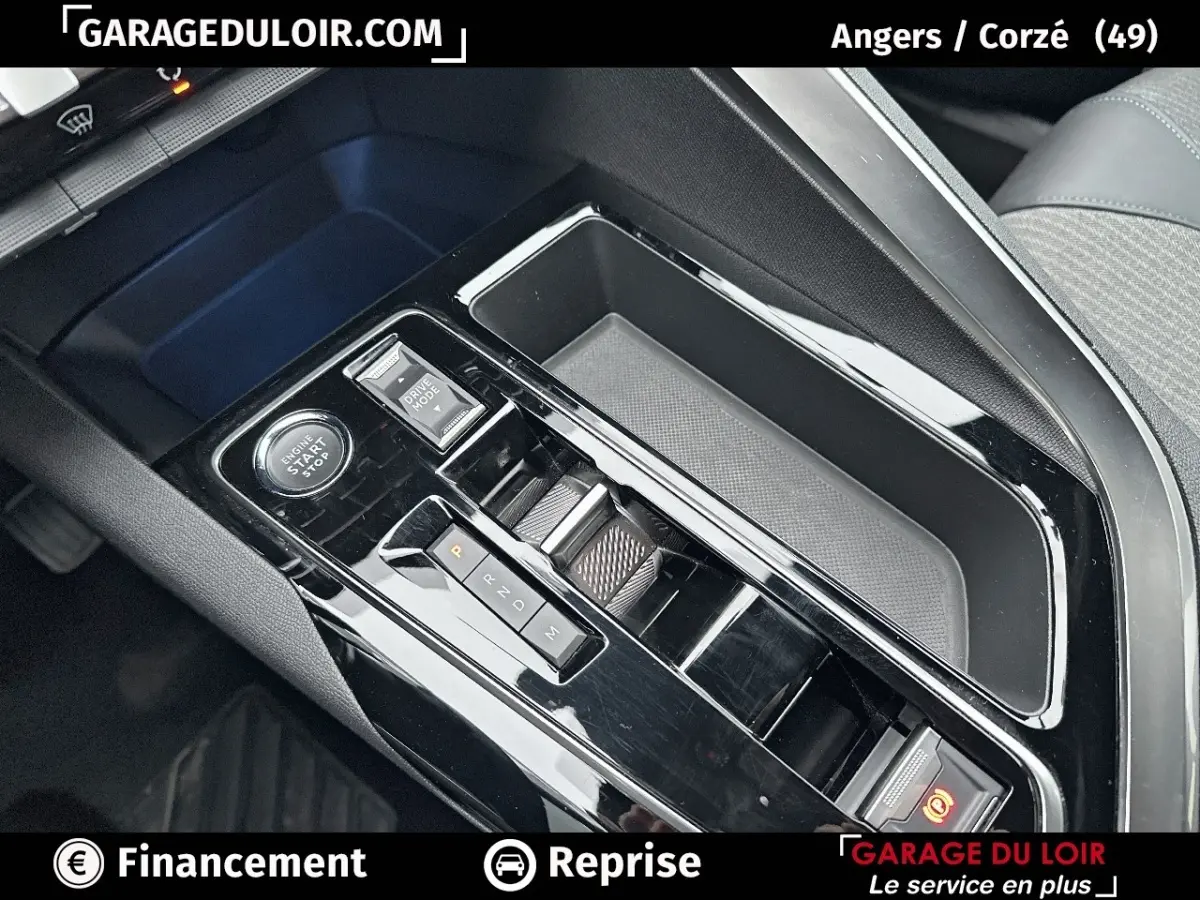 Vue rapprochée de la console centrale noire brillante avec levier de vitesses et bouton start/stop du Peugeot 3008 blanc 2024.