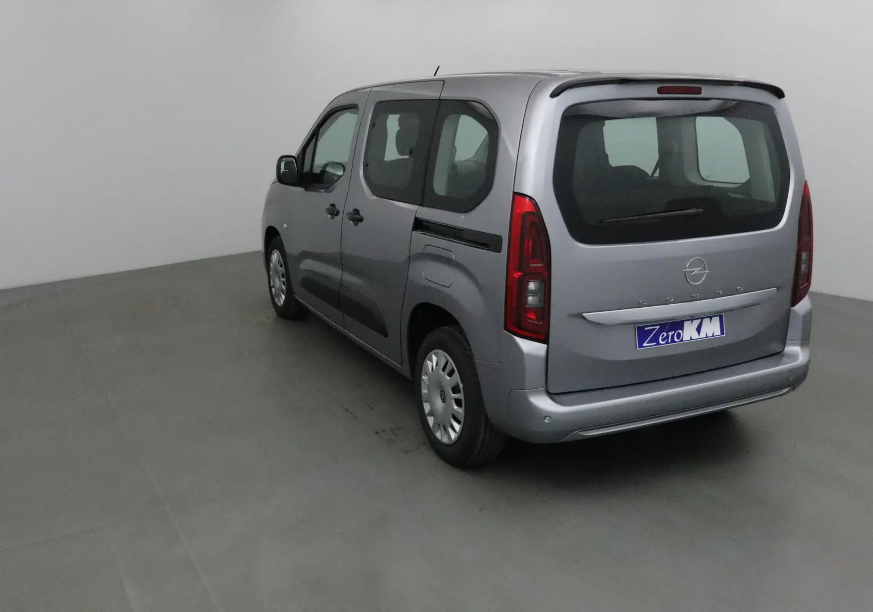 Opel Combo Life gris Artense vu en 3/4 arrière droit avec becquet et vitres teintées arrière.