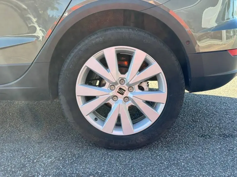 Gros plan sur la roue arrière droite d’un SEAT Arona noir, mettant en valeur la jante alu à 10 branches.