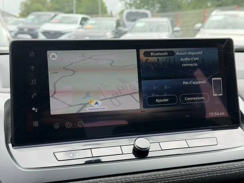 Écran tactile central du Nissan Qashqai 2025 affichant la navigation et les options Bluetooth en intérieur.