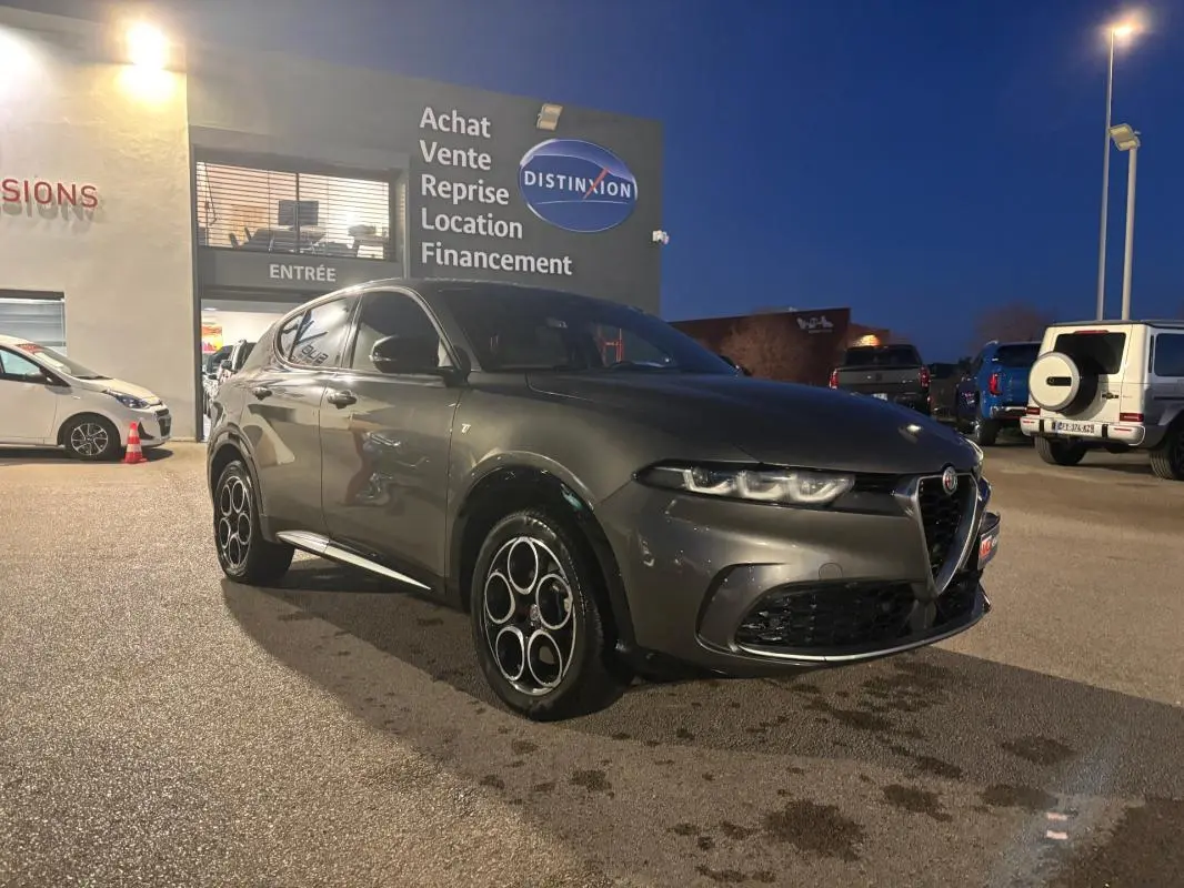 Vue 3/4 avant gauche d'une Alfa Romeo Tonale gris métallisé avec jantes alliage distinctives en cercle.