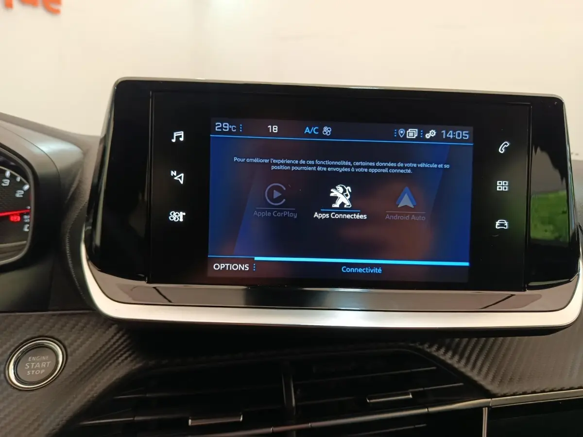 Écran tactile central du tableau de bord du Peugeot 2008 bleu, avec interface Apple CarPlay et Android Auto visible.