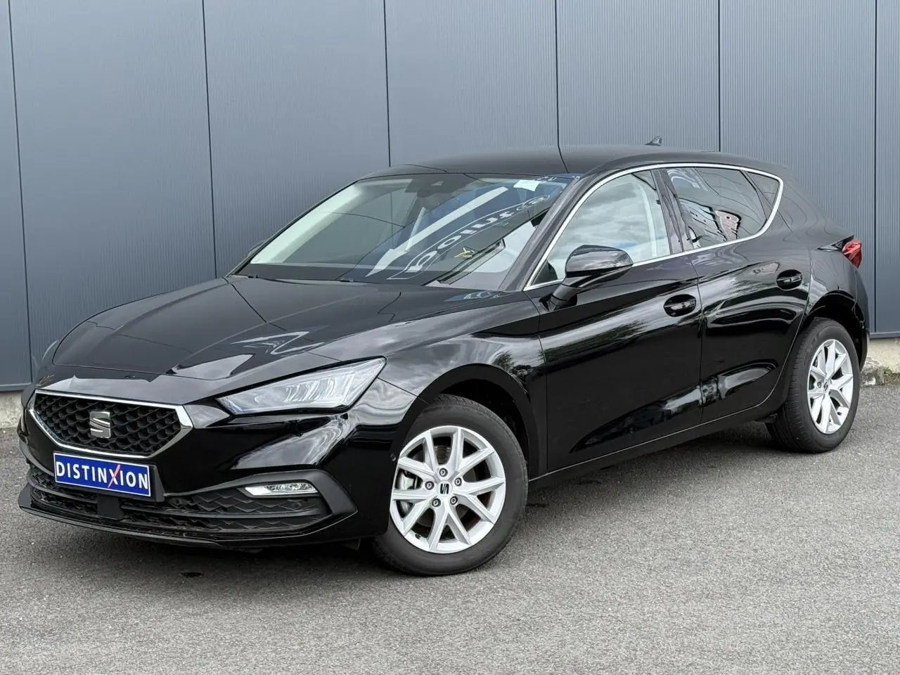 SEAT Leon noir Minuit en 3/4 avant droit, avec jantes alliage 16 pouces et calandre chromée.