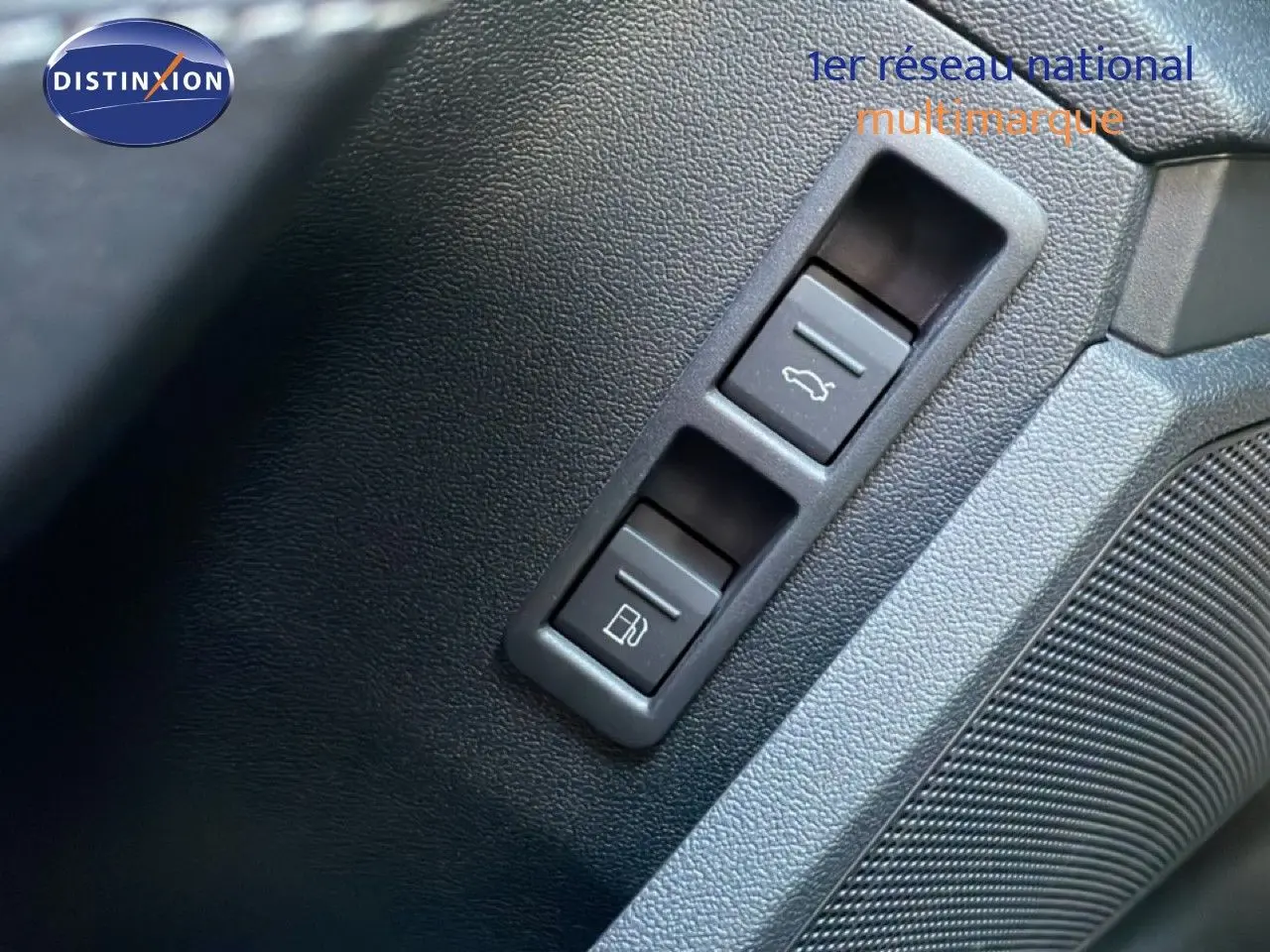 Gros plan sur les boutons d'ouverture du coffre et de la trappe à carburant dans l'habitacle noir de l'Audi A3 Sportback 2025.
