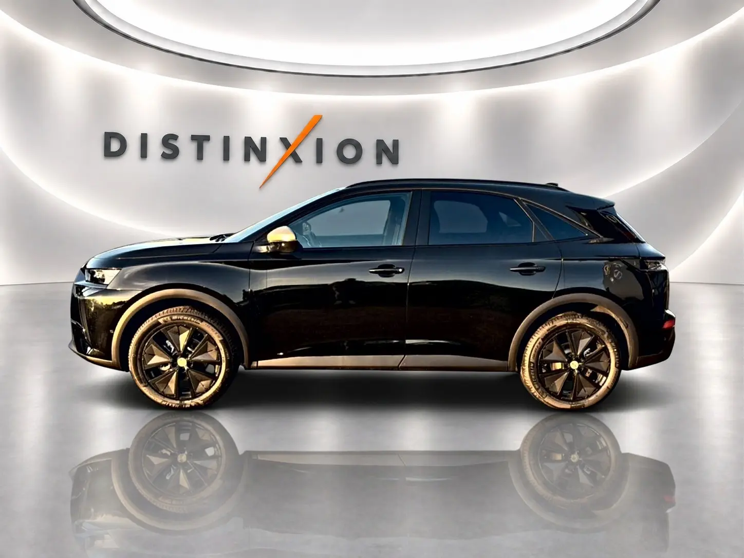 Vue de profil côté gauche d’un DS7 noir 2026 avec jantes noires et rétroviseurs dorés dans un showroom lumineux.