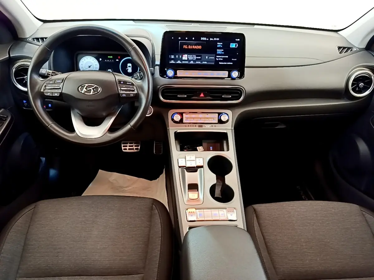 Vue intérieure du tableau de bord et volant cuir multifonctions du Hyundai Kona électrique 2023, avec écran tactile central.