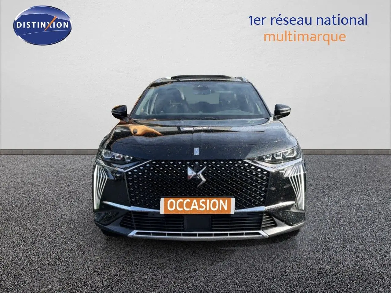 Vue de face du DS7 1.5 BlueHDi 130 en noir perle, mettant en valeur sa calandre distinctive et ses feux LED verticaux.