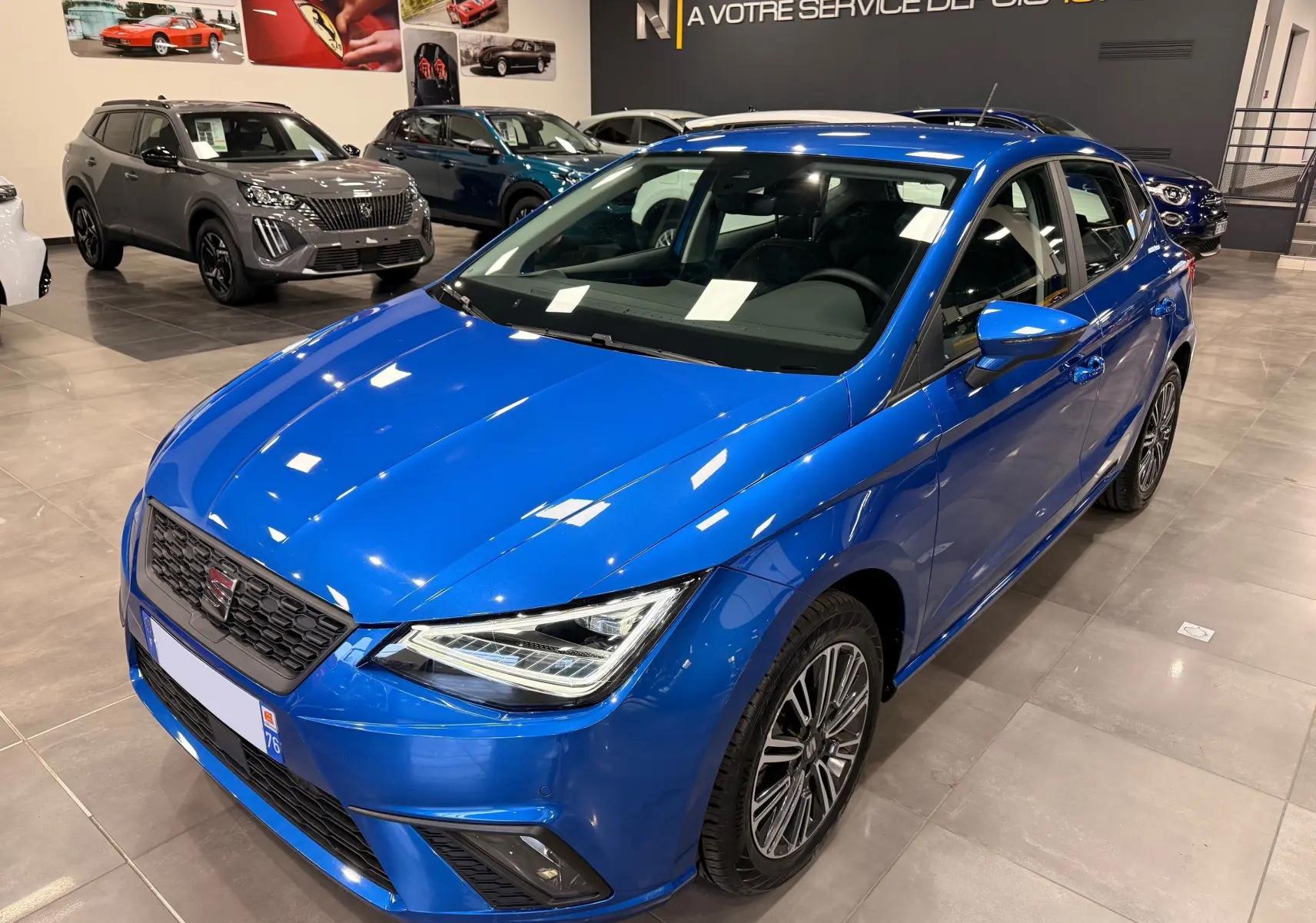 SEAT Ibiza 1.0 TSI 95CH Copa bleu vue 3/4 avant droit en intérieur, avec jantes alliage et phares LED.
